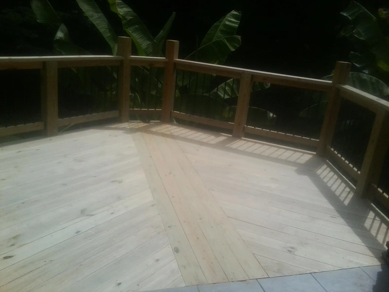 New wood deck and railing built off the back of a home in Troutman